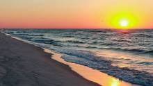 View of the beach and waves on 30A while the sun sets