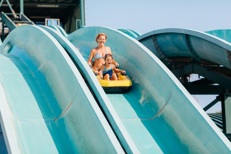 mom and daughter sliding down waterslide