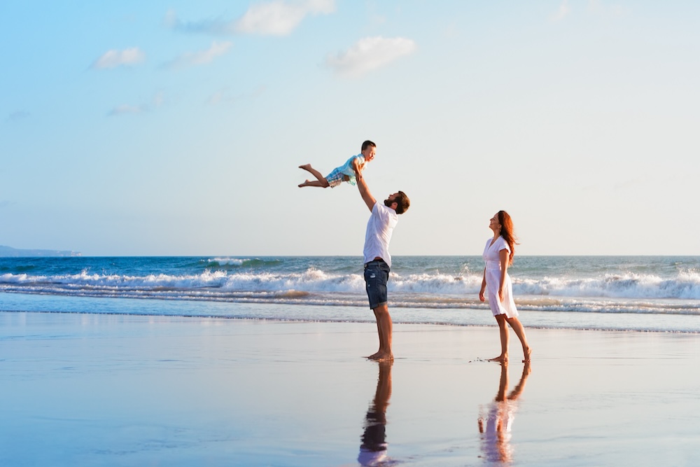 Family playing on the beach