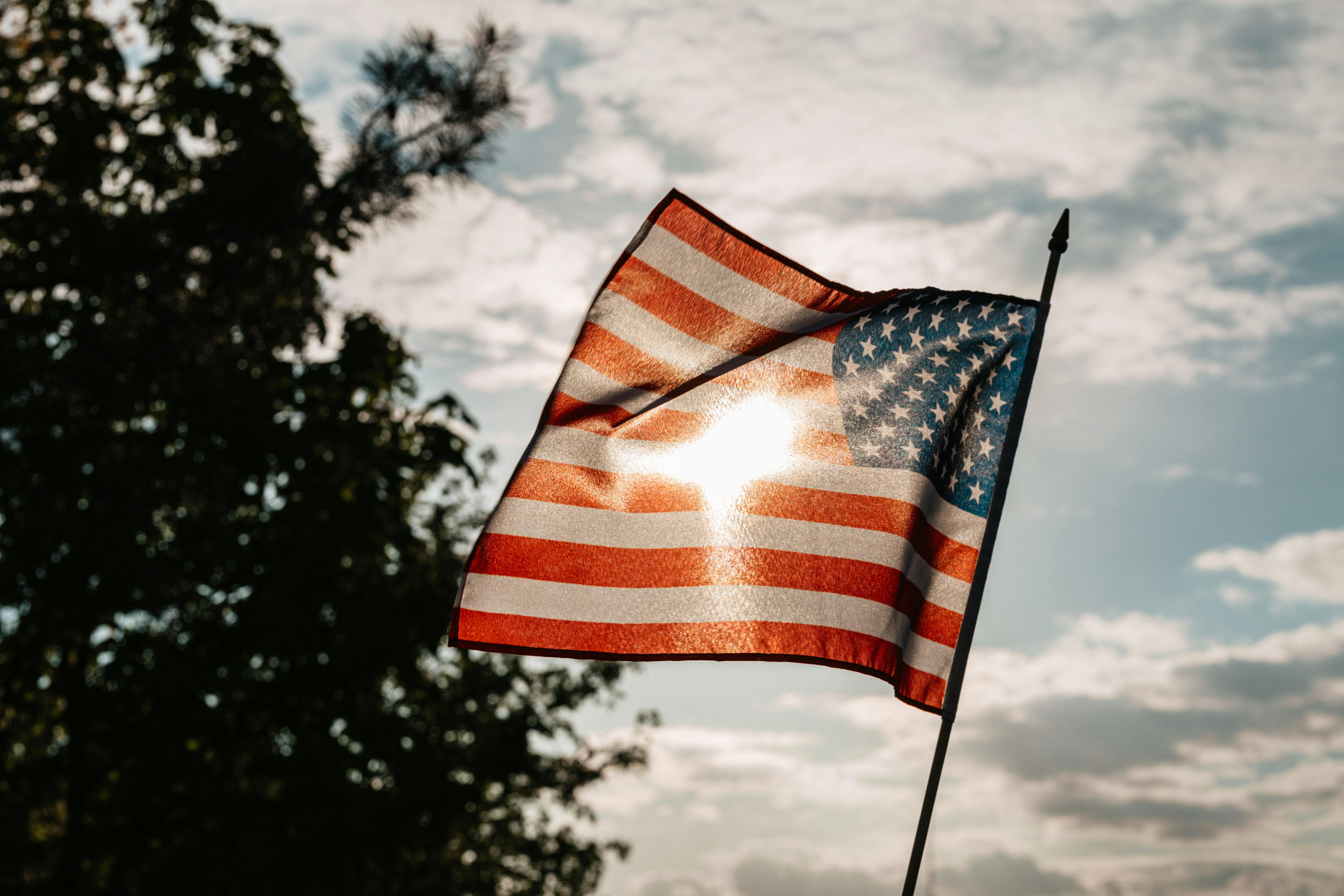 American flag with blue sky in the background American flag with blue sky in the background